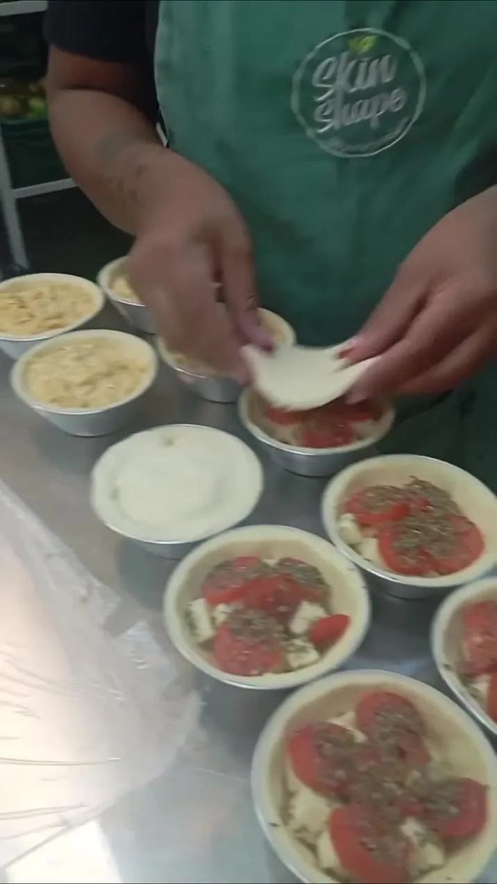 Mãos da equipe montando empadinhas sem glúten e sem lactose